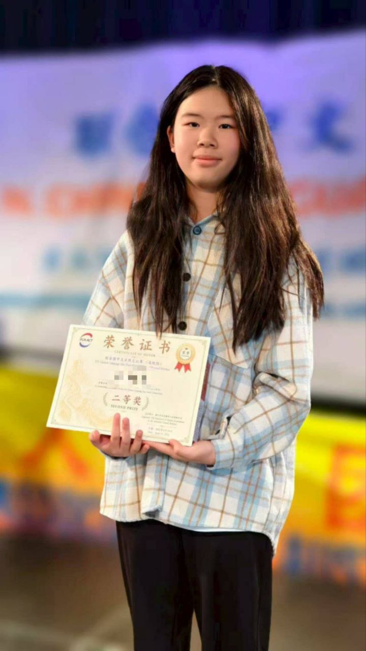 Student holding an award certificate at the 2026 competition