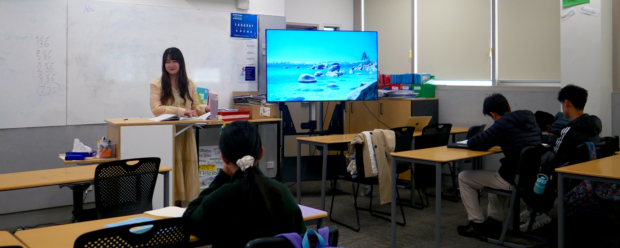 A teacher using digital learning materials in a Canberra Chinese School classroom